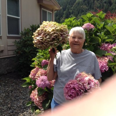 Jackie with a giant hyacinth bloom at her house in Powers, OR, Aug 5, 2017