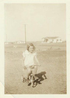 Jackie as a child on a tricycle
