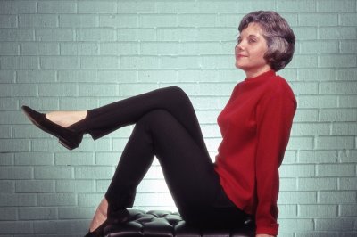 Jackie posing for Bill in black tights and red sweater at the house on 49th St
