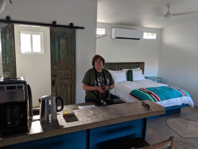 Mary in the kitchen with the sleeping area to the upper right