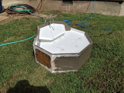 Proof of concept #2: plugged in the pump and water began to flow. I hadn't leveled the fountain or the reservoir, so water was running out of the tub underneath, but the design worked.