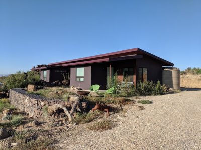 View of the B&B from the NE; you can see one of the 3 rain-capture barrels behind the building