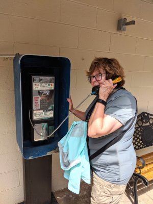 On the wall outside the restaurant, Mary found an antique--a pay telephone--and had to try it out.