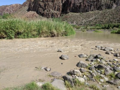The recent rains had the river flowing fast and muddy.