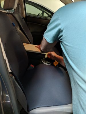 Before attaching the top half to the base plate, I tested the fit of the brackets on the armrest in the car, a Honda CRV.