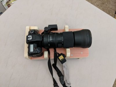 Nikon D7500 camera with 150-600mm Sigma lens sitting on the camera cradle