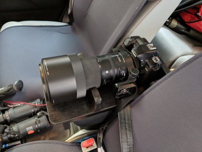 Camera and lens on the cradle in the car