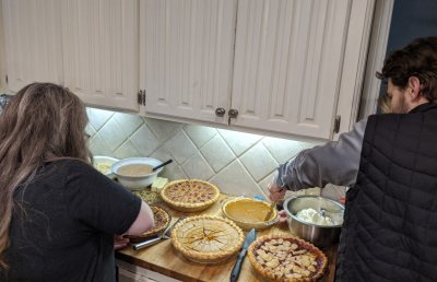 Heather and Seth start cutting the pies