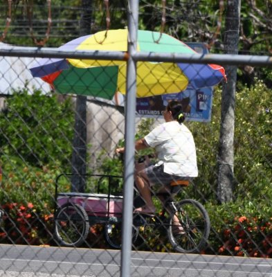 This vendor was pedaling by in the traffic outside the mercado.