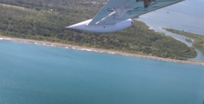 The wingtip and coast below