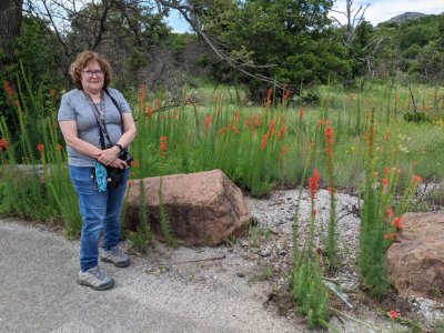 Mary posed with these upright red flowers we've seen at the refuge before in different places: Standing Cypress (Ipomopsis rubra).