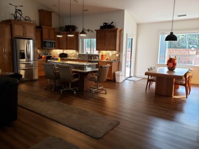 The living space is open, with a high ceiling.
Looking at the kitchen and dining area