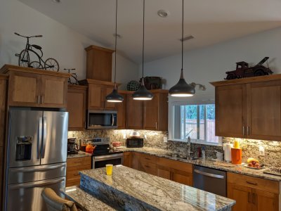 Notice the antique trikes and toy truck above the kitchen cabinets