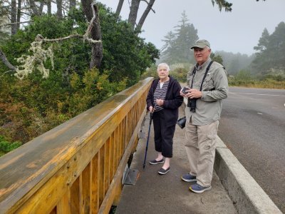 Wednesday morning Pepper and Kathy had appointments, so we took Jackie and headed out for another day of adventure, driving south, down the coast from Florence. Our first stop was one Mary and I had made the day before, along the Siltcoos River in the Oregon Dunes National Recreation Area.
Jackie and Steve, on a bridge over the Siltcoos River