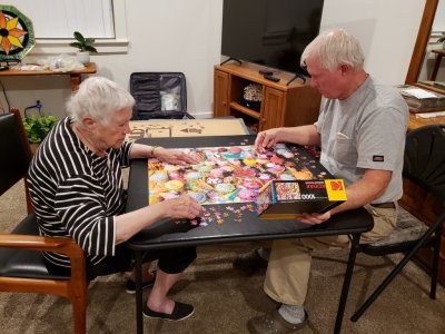 Jackie works by the shapes of the pieces and their colors; Steve looks at the picture of the puzzle and tries find where the pieces go. Different strategies, but they work well together--except when one of them has a piece the other one needs.
