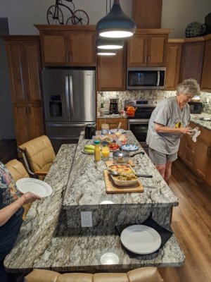 Our final morning spread--Kathy setting it out, Mary with plate in hand, ready to eat.