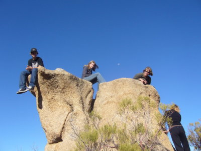 Rock Sitting - Moon in the background sky