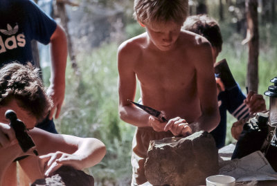 Brad Something about an axe, chisel, large rock, and camp lantern.