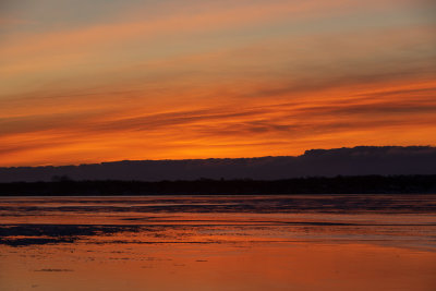 Orange and yellow skies reflected in the Bay of Quinte