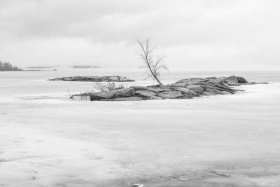 Two small islands along the Bay of Quinte on a foggy afternoon