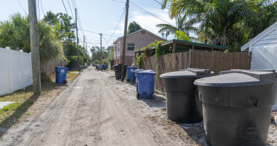 Trash and Recyicling for both sides of the alley and for these houses facing the paved street