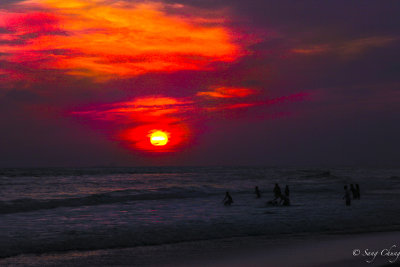 children chasing the setting sun