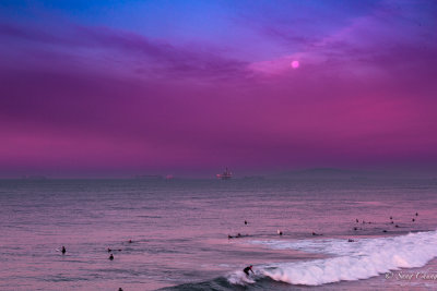 surfers and setting full moon