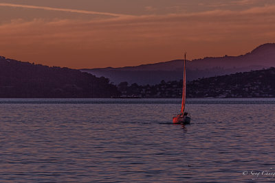 a boat with setting sun at Berkeley Marina