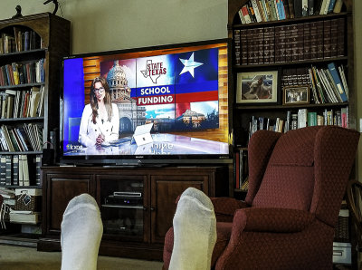 Kickin' back watching the evening news, co- anchored by Sydney Benter, Austin, TX . (4/6) 