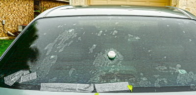 Golf ball hailstorm damages car window 