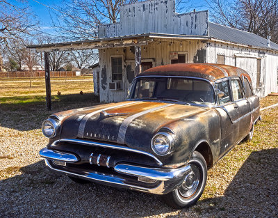 Pontiac Hearse. About 1955 I think, but I could not find this grill configuration.