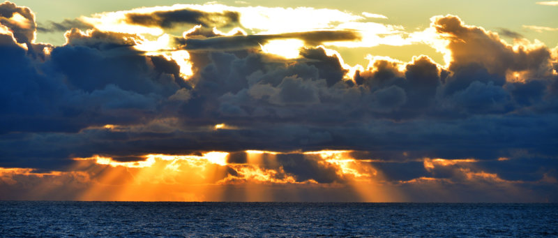 Suns rays light up the horizon.