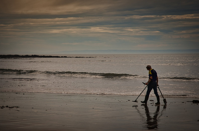 Hunting for treasure at Langland Bay.