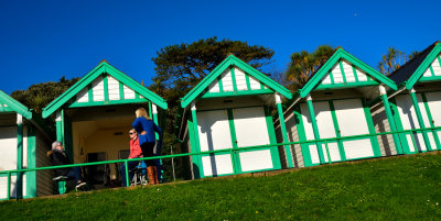 Enjoying the late November sunshine in the iconic Langland Bay beach huts.