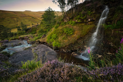 Small waterfall and heather. Pen-y-Fan in the background.