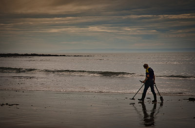 Hunting for treasure at Langland Bay.