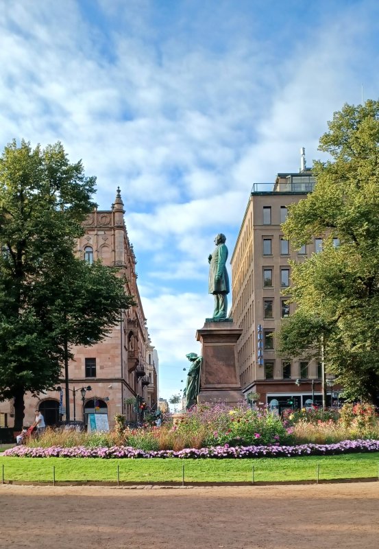 Statue of Johan Ludvig Runeberg-author, national poet & priest- below a woman wrapped in bearskin, symbolising Maiden of Finland