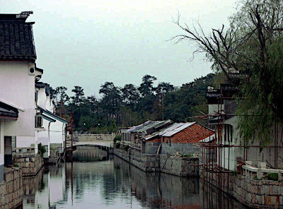 Quiet canal under a noisy city street