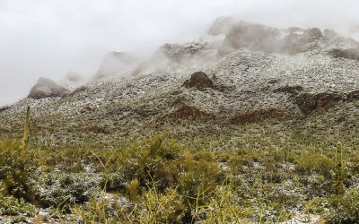 Tucson Mountains in the clouds and covered by snow in Tucson Mountain Park