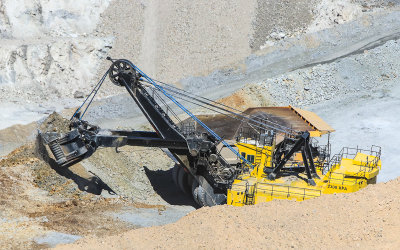An excavator shovel scoops a load for a haul truck in the ASARCO Copper Mine