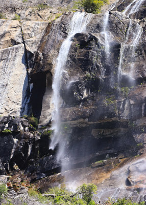 Wind alters the path of a small waterfall in the Hetch Hetchy Valley of Yosemite NP