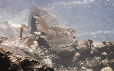 Searchers look for a lost hiker on the rocks below Wapama Falls in the Hetch Hetchy Valley of Yosemite NP