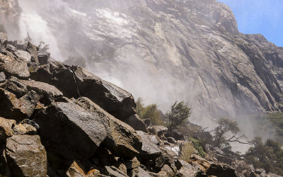 Mist from Wapama Falls crashing into the rocks at its base in the Hetch Hetchy Valley of Yosemite NP