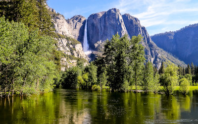 Early morning view of Yosemite Falls over the swollen Merced River in Yosemite National Park