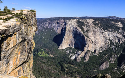 Taft Point (7,503 ft.; see railing on top left) with El Capitan in the valley below in Yosemite National Park