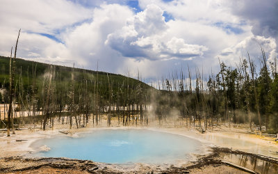 Clouds gather over Cistern Spring in the Norris Geyser Basin in Yellowstone National Park
