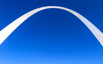 The 630 foot tall span of Gateway Arch lit by the sun in Gateway Arch National Park