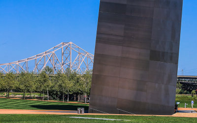 The MLK Bridge over the Mississippi River with the northern leg of Gateway Arch in Gateway Arch National Park