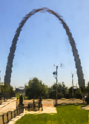 Gateway Arch viewed through a timeworn window in the Old Courthouse in Gateway Arch National Park