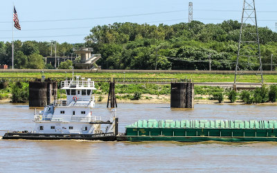 Tug boat on the Mississippi River with the Malcom Martin Memorial Park deck in the background